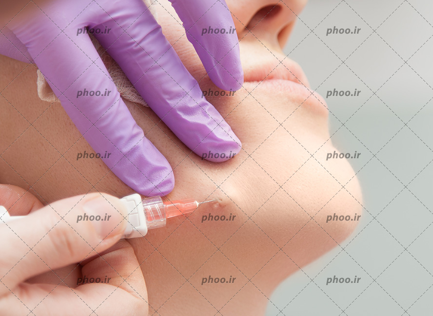 عکس با کیفیت پزشک در حال تزریق کردن ژن به فک زن از نمای نزدیک