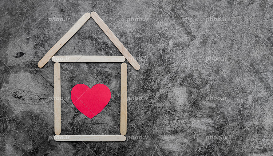 عکس با کیفیت درخت کردن خانه ی دو بعدی با کمک چوب بستنی و قرار گرفتن قلب قرمز در خانه به معنی زندگی