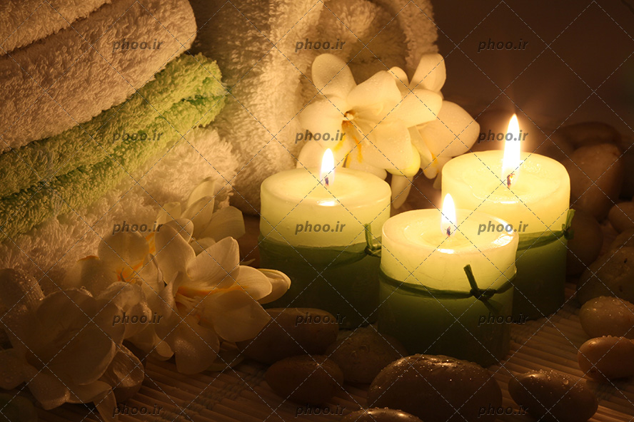 عکس زیبا ماساژ با وسایل نمک و شمع و گل با حوله